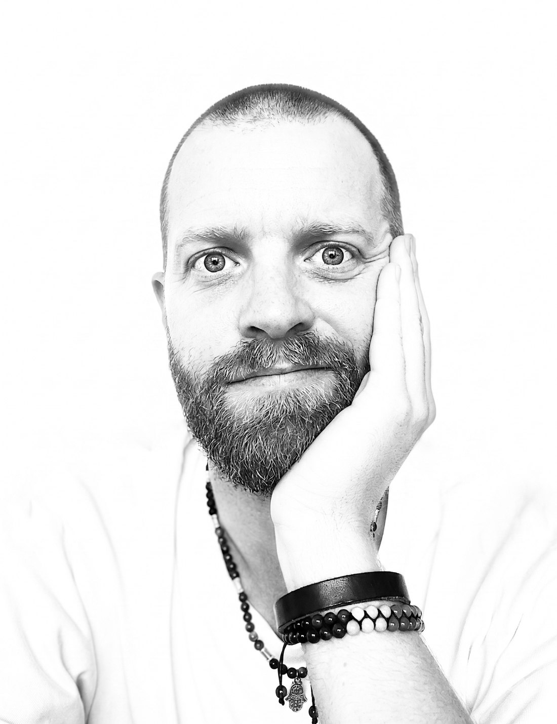 Jon Uland, black-and-white portrait, chin resting on his hand